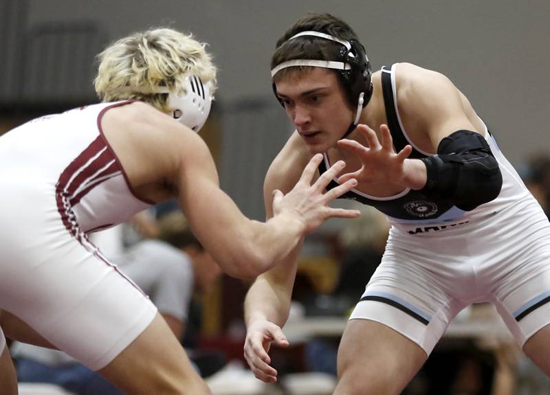 Marian Central’s Nic Astacio battles with Wheaton Academy’s Tyler Jones  in the 165-pound championship match of the IHSA 1A Marengo Wrestling Regional on Saturday, Feb. 8, 2025, at Marengo High School.
