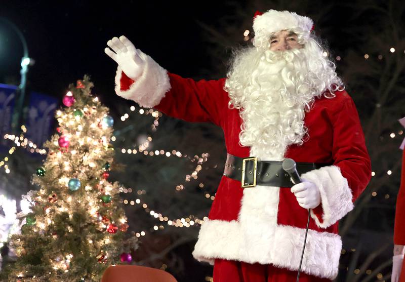 Santa waves at visitors in front of the Egyptian Theatre before lighting the tree Thursday, Dec. 1, 2022, during the DeKalb Chamber of Commerce Lights on Lincoln and Santa Comes to Town.