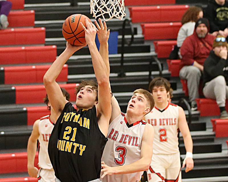 Putnam County's Orlando Harris (21) runs in the lane past Hall's Max Bryant (3) to score a basket during the Colmone Classic on Tuesday, Dec. 6, 2022 at Hall Hight School in Spring Valley.