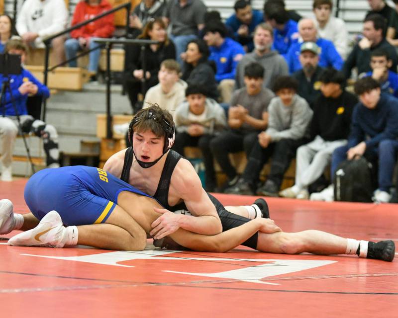 Aston Hobson of Marmion Academy,right, stretches out during the 157-weight class regional meet while taking on Vince Guttierrez of Sandburg on Tuesday Feb. 25, 2025, held at Yorkville High School.
