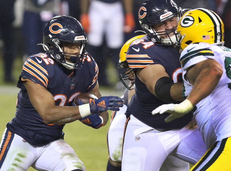 Chicago Bears running back David Montgomery (32) follows the block of Chicago Bears center Alex Bars (64) during their game Sunday against the Packers at Soldier Field in Chicago.