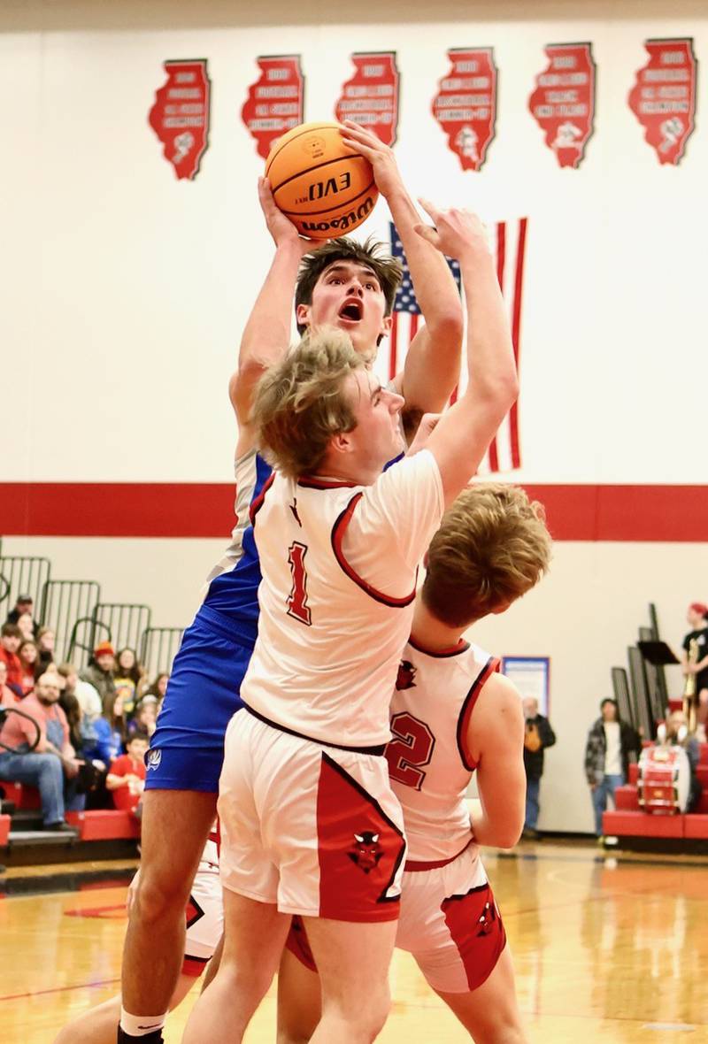 Princeton's Noah LaPorte shoots over Hall's Wyatt West Friday night at Hall High School. The Red Devils won 62-54.