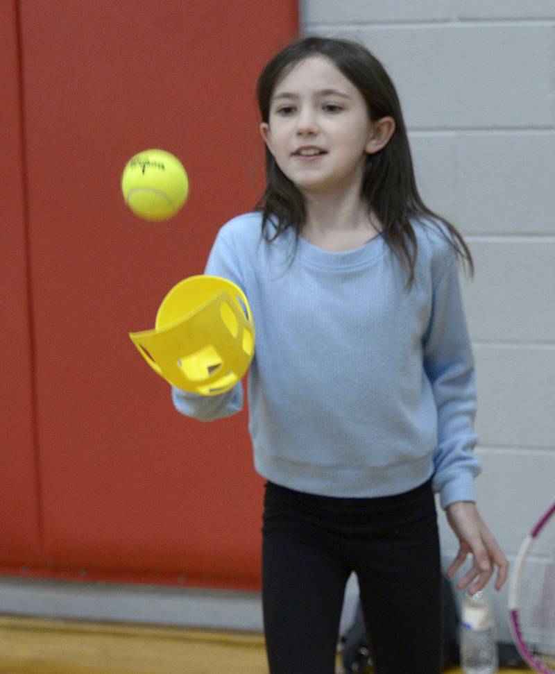 Karrington Byrne follows the bouncing ball during a quick tennis match Saturday, April 20, 2024, during the Healthy Kids Day at the Streator Y.