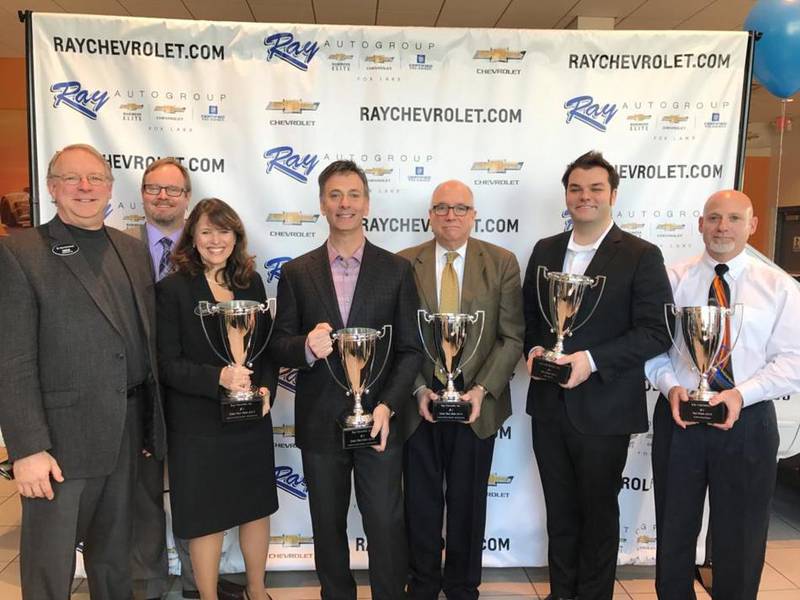 Mike Pekarscik, district manager of GM Fleet and Commercial (from left); Ted Pfister, zone manager of GM Fleet and Commercial; Susan Keenehan, regional director of North Central Region GM Fleet and Commercial; Ray Scarpelli, dealer principle of Ray Chevrolet; Brian Farrar, Ray Chevrolet Fleet and Commercial director; Ray Scarpelli III‚ sales manager; and Scott Kalish, Ray Chevrolet Fleet and Commercial manager, pose with trophies awarded to Ray Chevrolet after General Motors named it its top Business Elite dealer in the U.S.