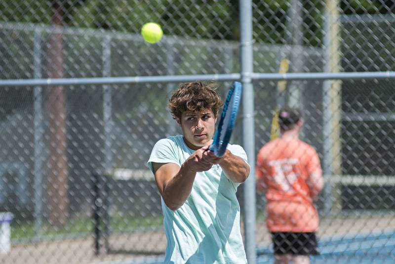 Ryan Partington returns a shot while playing in the 15 and under boys single tournament during the Emma Hubbs tennis classic in Dixon.