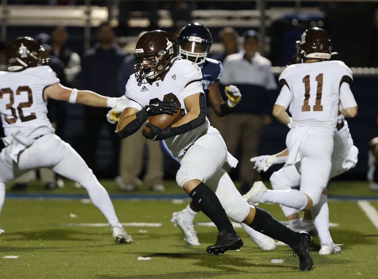 Joliet Catholic's Nate Magrini (28) runs the ball during the varsity football game between Joliet Catholic and Nazareth academies on Friday, Sep. 27, 2024 in La Grange Park.