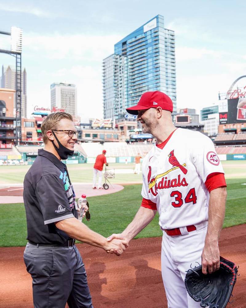 St. Bede alums Kyle Dinges ('95) and J.A. Happ ('01) meet on the field before Friday's game at Busch Stadium.