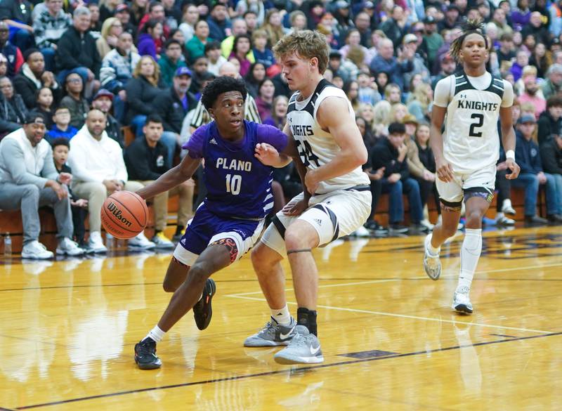 Plano's Davione Stamps (10) drives the baseline against Kaneland’s Parker Violett (34) during a championship game of the 60th annual Plano Christmas Classic Basketball Tournament at Plano High School on Saturday, Dec 30, 2023.