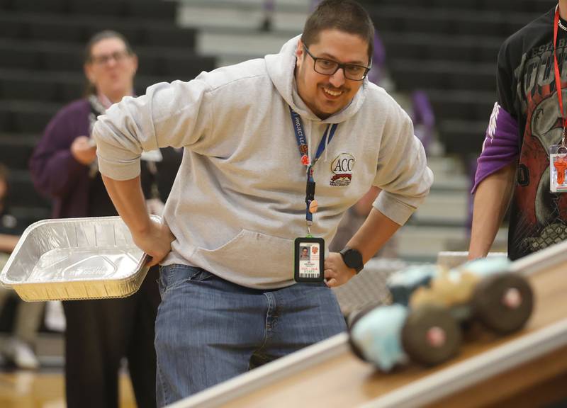 Andrew Wiercinski, CTE instructor at La Salle-Peru Township High School, watches his car speed down the ramp during the Edible Car Contest on Wednesday, Feb. 25, 2026 at Illinois Valley Community College in Oglesby.