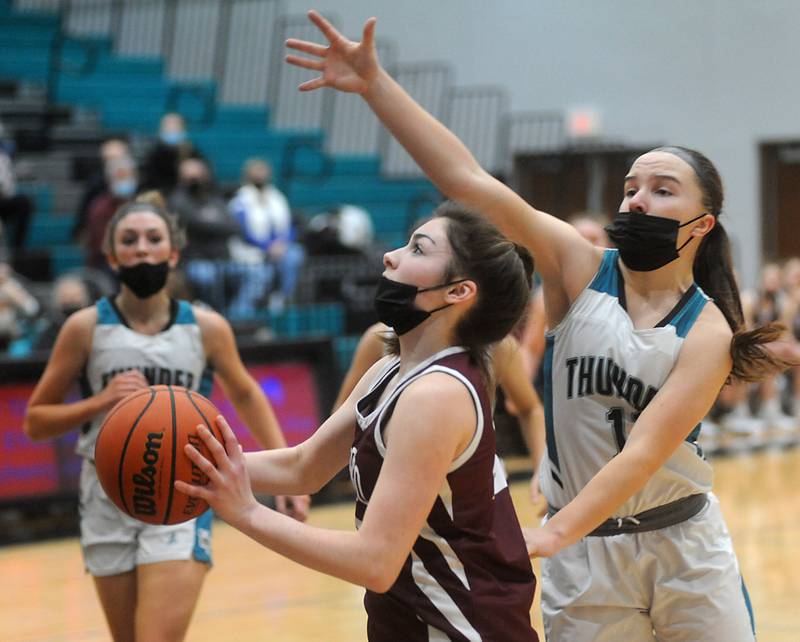 Marengo’s Bella Frohling drives to the basket against Woodstock North's Gracie Zankle during the first quarter of a Kishwaukee River Conference game Jan. 12, 2022 in Woodstock.