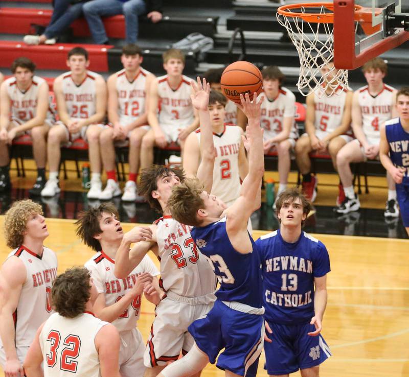 Newman's Lucas Simpson runs in the lane to score on a layup against Hall defenders on Friday, Feb. 3, 2023 at Hall High School.
