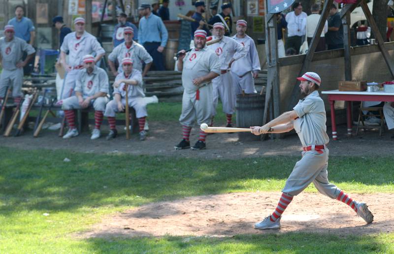 Oregon Ganymede Brett Rogers connects on a pitch for a hit as his teammates watch at the World Tournament of Historic Base Ball held at the Henry Ford Museum's Greenfield Village on Saturday, Aug. 9, 2025.