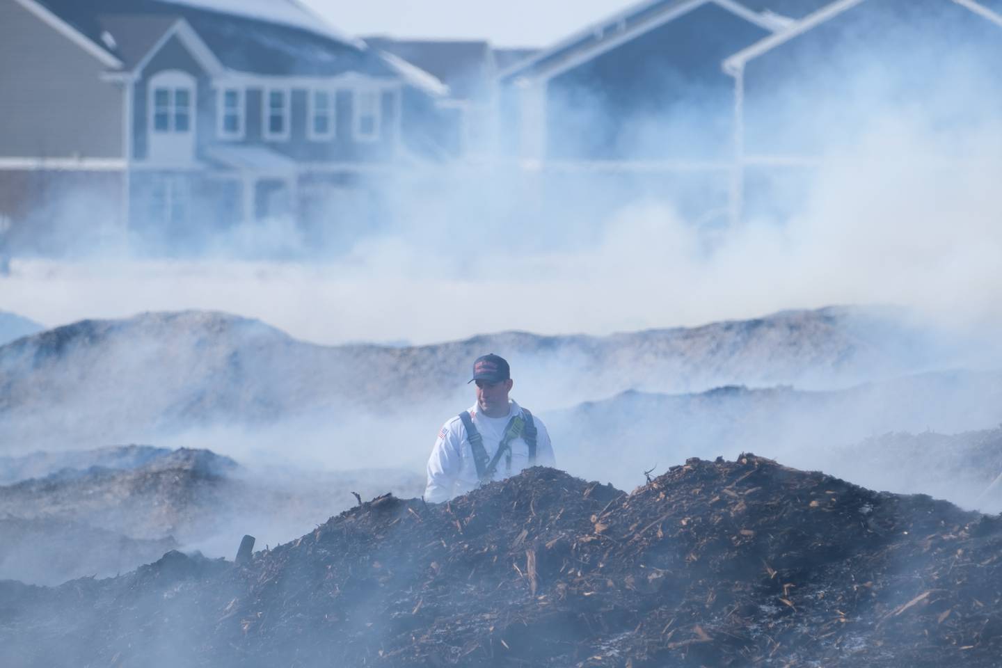 A New Lenox firefighter inspects piles of smoldering mulch at 815 Mulch It in New Lenox. Monday, Jan. 31, 2022 in New Lenox.