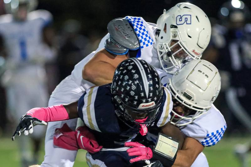 St Francis's Dom Beres (5) assists with a tackle during varsity football game at IC Catholic Prep.  Oct 21, 2022
