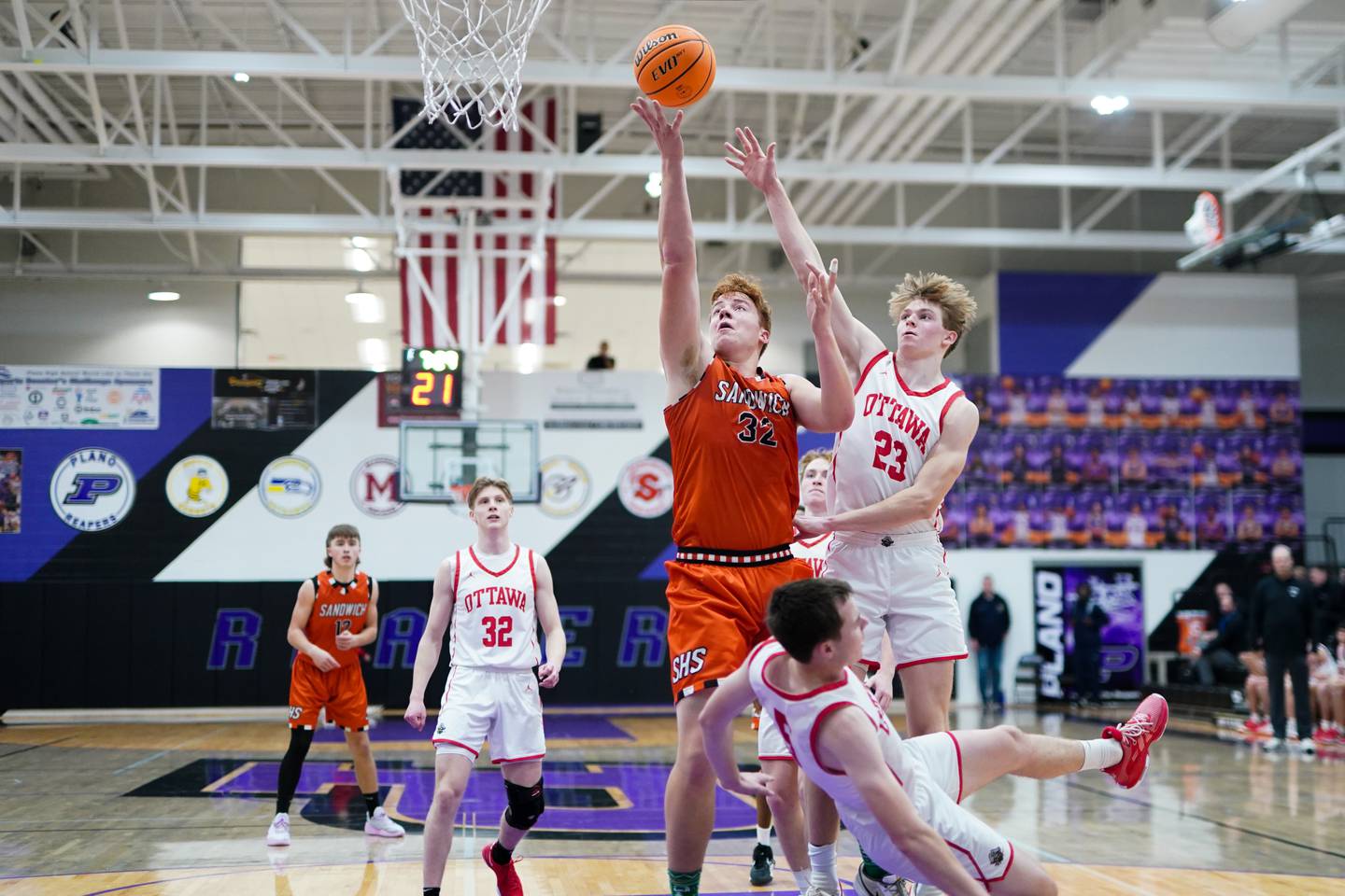 Sandwich’s Quinn Rome (32) shoots the ball in the post against Ottawa’s Kyler Araujo (5) and Owen Sanders (23) during a basketball game in the opening round of the 61st annual Plano Christmas Classic at Plano High School on Monday, December 23, 2024.