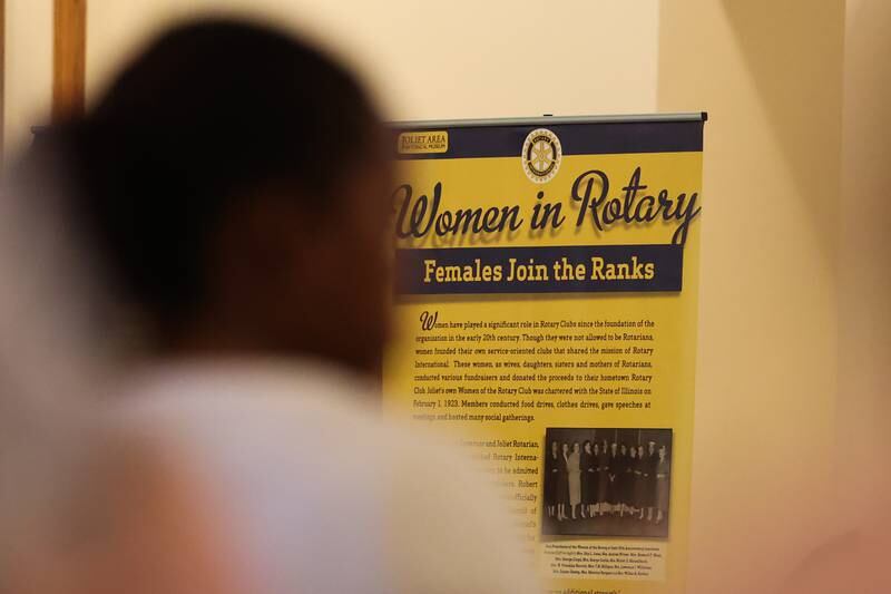 A banner on the Women of Rotary hangs at a luncheon to celebrate the 110th anniversary of the Rotary Club at Jacob Henry Mansion on Tuesday, Aug. 1 in Joliet.