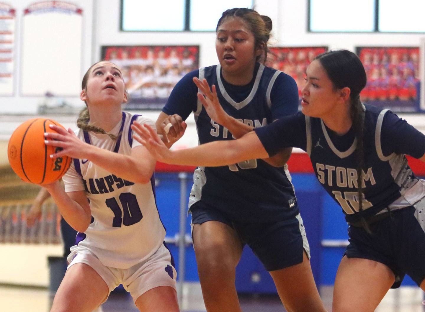 Hampshire’s Peyton McCarthy, left, works against South Elgin’s Janessa Price, center, and Anevay Hernandez in varsity girls basketball Komaromy Classic tournament  action on Monday, Dec. 29, 2025, at Dundee-Crown High School in Carpentersville.