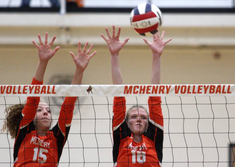 McHenry’s Sophie Zieba, left, and Ella Boland block against Crystal Lake South in varsity volleyball at McHenry Tuesday night.