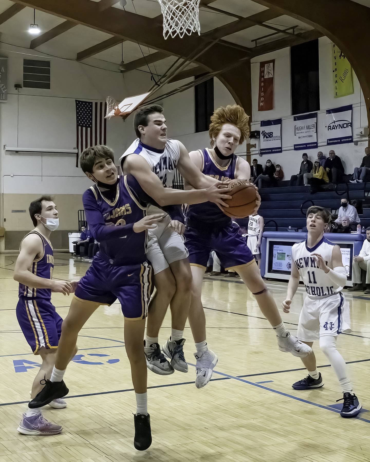 Newman's Ethan Van Landuit (middle) fights to come down with a rebound against Mendota's Izaiah Nanez (left) and Ryne Strouss as Mendota's Ted Landgraf (far left) and Newman's Mario Passini (11) look on during their Three Rivers East game Friday night in Sterling.