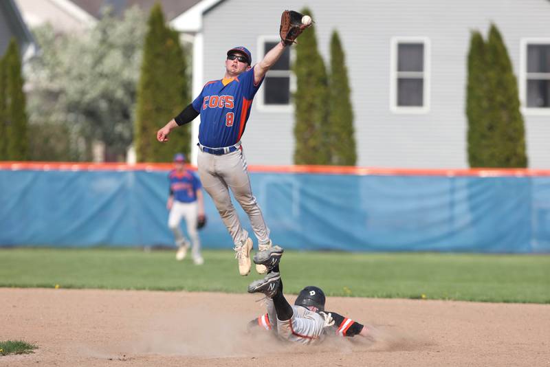 Genoa-Kingston's Nolan Perry leaps to try and catch a throw as Byron's Ashton Henkel steals second during their game Tuesday, May 10, 2022, at Genoa-Kingston High School.