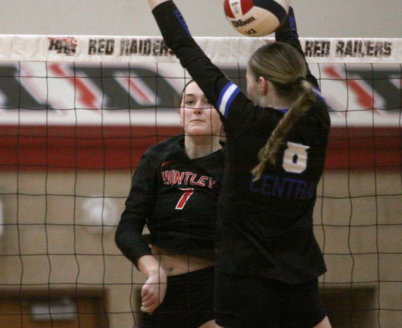Huntley’s Jocelyn Erling, left, watches her shot sail past Burlington Central’s Ainsley Wilson in varsity volleyball at Huntley High School in Huntley on Thursday, Oct. 24, 2024.