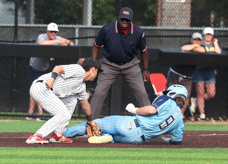 Marquette's Jaxsen Higgins is thrown out at third as Fulton's Braeden Brennan applies the tag Monday, June 2, 2025, during their Class 1A supersectional game at Northern Illinois University in DeKalb.