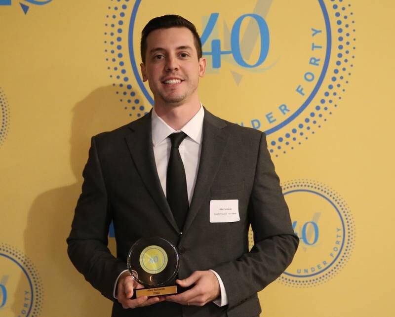 Alec Schwab poses for a photo with his award during the 40 Under Forty awards banquet on Thursday, March 21, 2024 at Westclox in Peru.