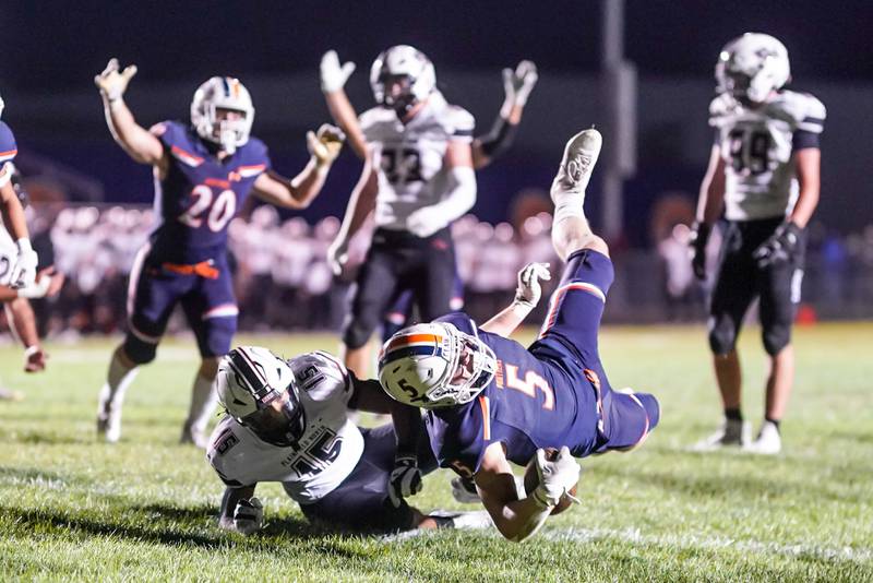 Oswego’s Carson Cooney (5) carries the ball for a touchdown against Plainfield North's Treycen Bownes (15) during a football game at Oswego High School on Friday, Sept. 27, 2024.