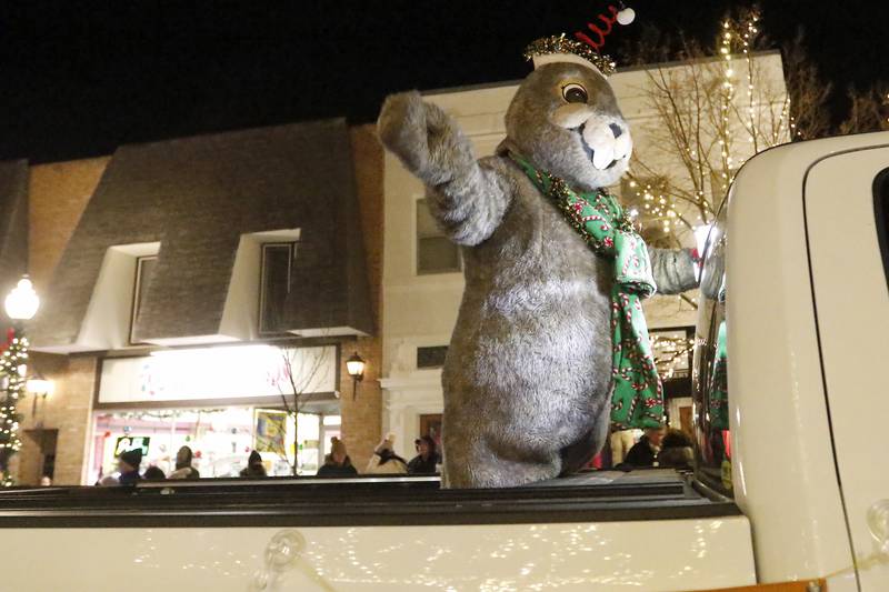 Woodstock Willie waves as he passes by during the annual Festival of Lights Parade on Friday, Nov. 26, 2021, in downtown Crystal Lake.