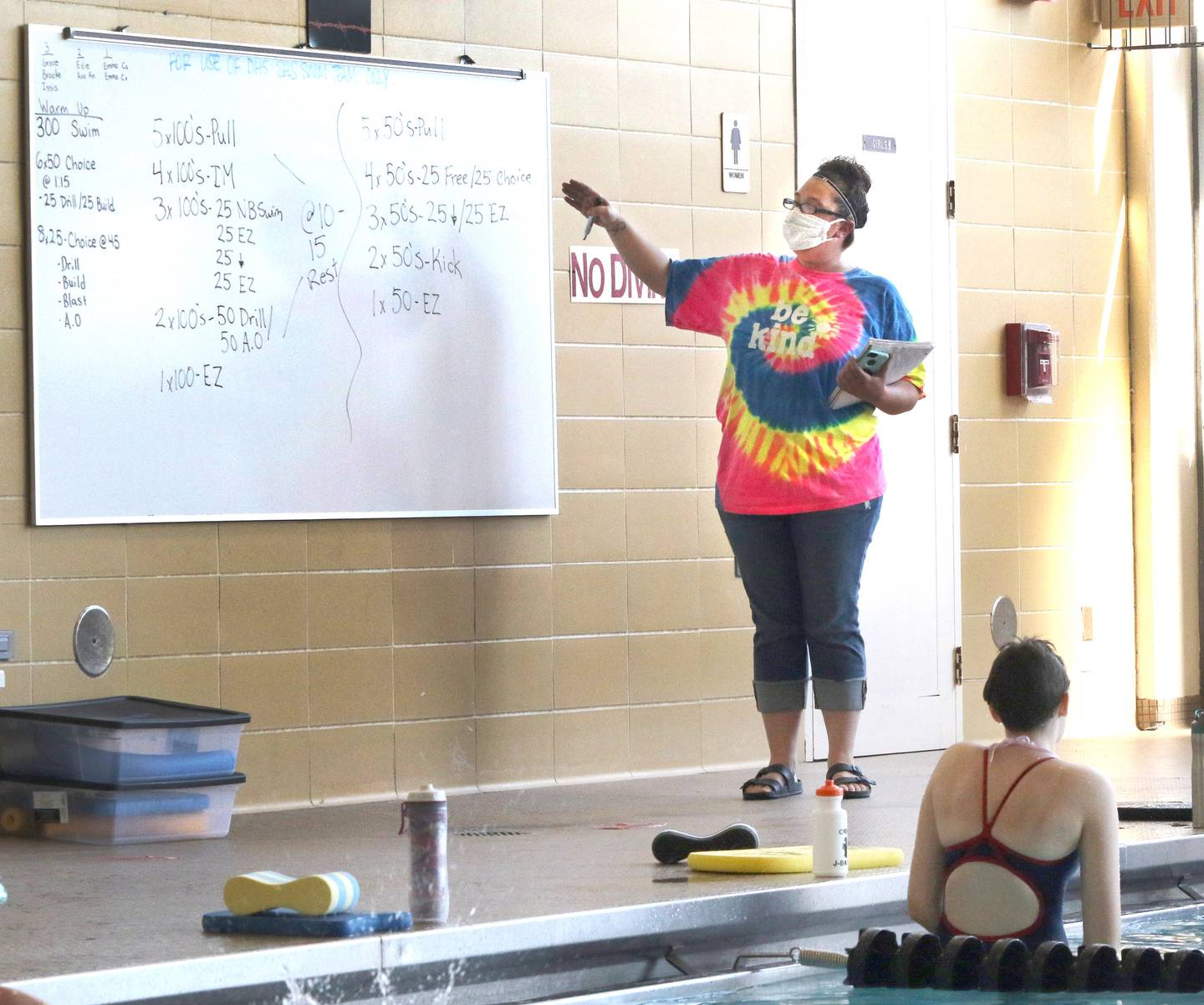 DeKalb-Sycamore girls swimming coach Melanie Chambers talks to her team Friday afternoon during practice at the Huntley Middle School pool in DeKalb.
