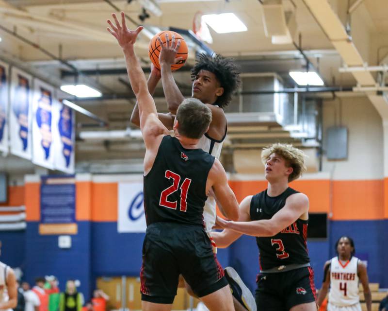 Oswego's Dasean Patton (23) puts up a contested shot during their basketball game between Yorkville at Oswego, Tuesday Dec 10, 2024 in Oswego.
