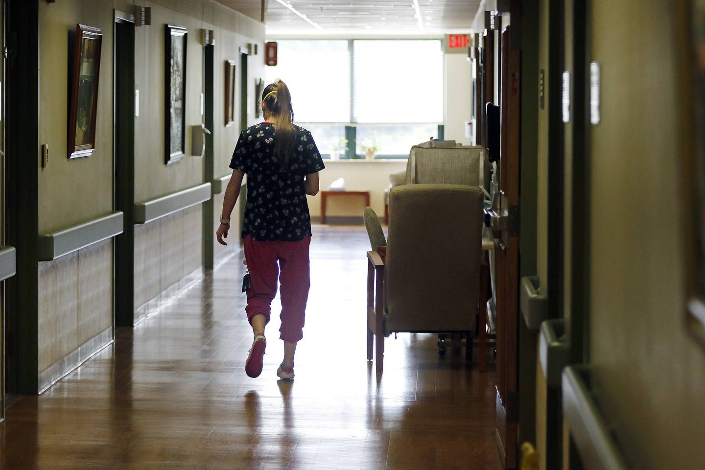 Rachel Reddick, CNA, heads down a hallway at Valley Hi Nursing Home on Tuesday, Aug. 17, 2021 in Woodstock.