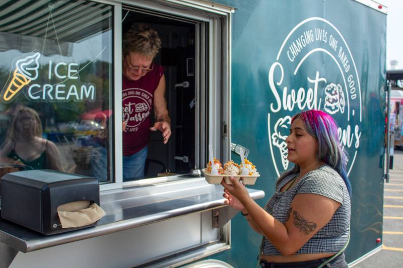 Diamond Mancilla, of Bradley, orders from Sweet Darren's food truck during the 5th annual Bourbonnais Food Truck Festival on Saturday, Aug. 16, 2025.