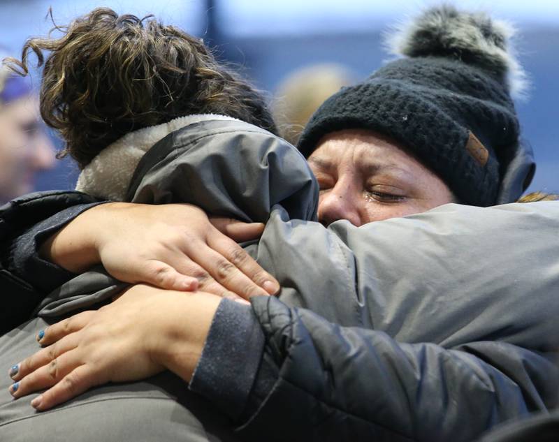 St. Margaret's employee Katherine Tradowski cries while she hugs Candice Jordan outside St. Margarets Hospital on Saturday, Jan. 28, 2023 in Peru. Employees and former employees gathered at the hospital after it closed at 7a.m. on Saturday morning. Hospital officials announced late last Friday their plans to suspend operations at St. Margaret's Health in Peru.