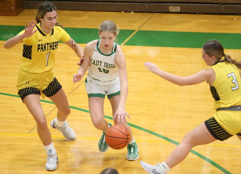 Seneca's Evelyn O'Connor dribbles between Putnam County defenders Ava Hatton and Gabby Doyle on Thursday, Jan. 4, 2024 at Seneca High School.