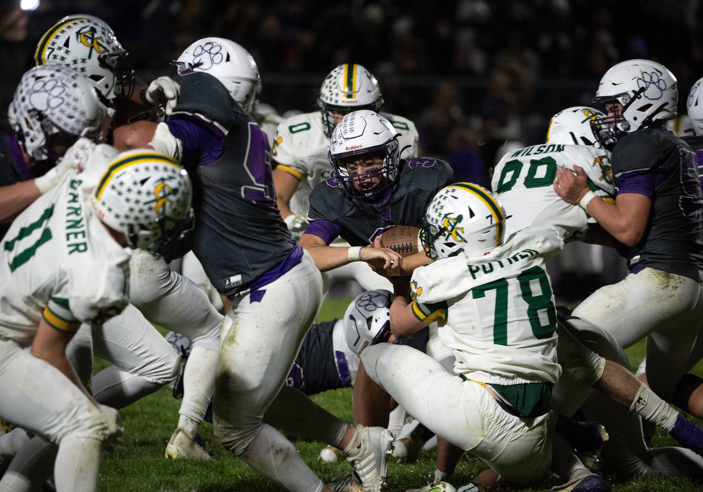Wilmington's Ryan Kettman, center, carries the ball as Coal City's Cade Poyner attempts the tackle in a game on Friday, October 24, 2025.