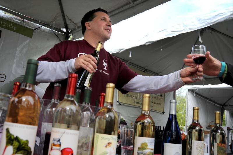 Steve Romala pours wine at the Prairie State Winery booth during the 2016 Wine on the Fox festival in Oswego. Prairie State will be among the participating wineries at this year's festival set for Saturday and Sunday in Hudson Crossing Park.