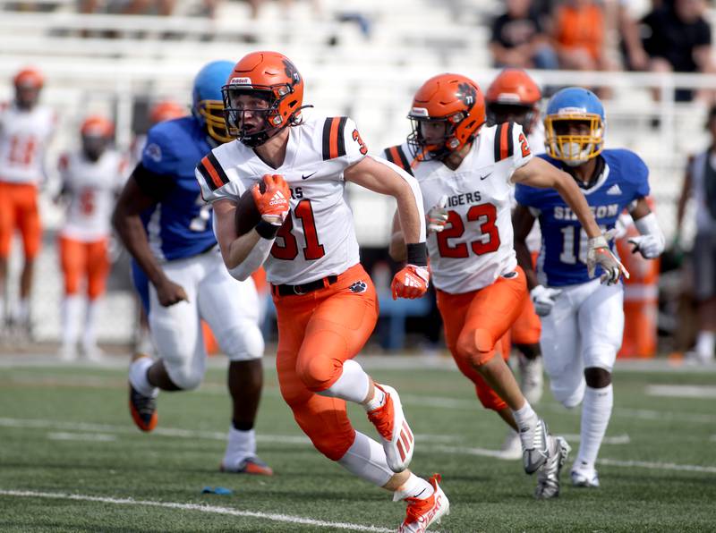 Wheaton Warrenville South’s Colin Moore runs the ball following a fumble recovery during a game against Simeon at Gately Stadium in Chicago on Saturday, Aug. 27, 2022.