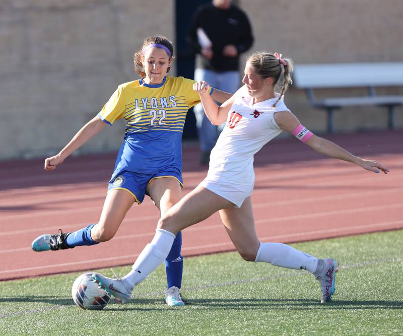 Lyons Township's Peyton Israel (22) fights for the ball against Hinsdale Central's Ava Elliott (10) during the IHSA Class 3A girls soccer sectional final match between Lyons Township and Hinsdale Central at Reavis High School in Burbank on Friday, May 26, 2023.