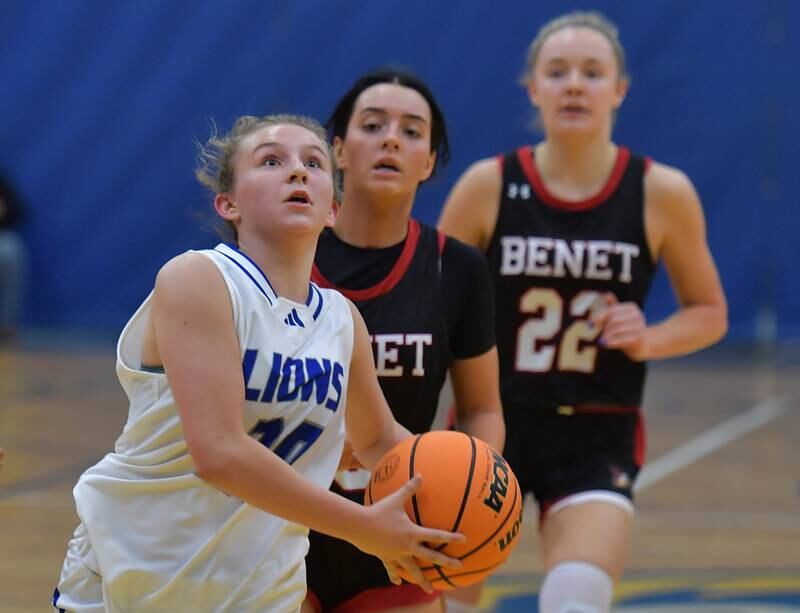 Lyons Township's Avery Mezan goes to the basket as Benet's Ava Thomas and Bridget Rifenburg (22) chase during a game on November 19, 2024 at Lyons Township High School in LaGrange.