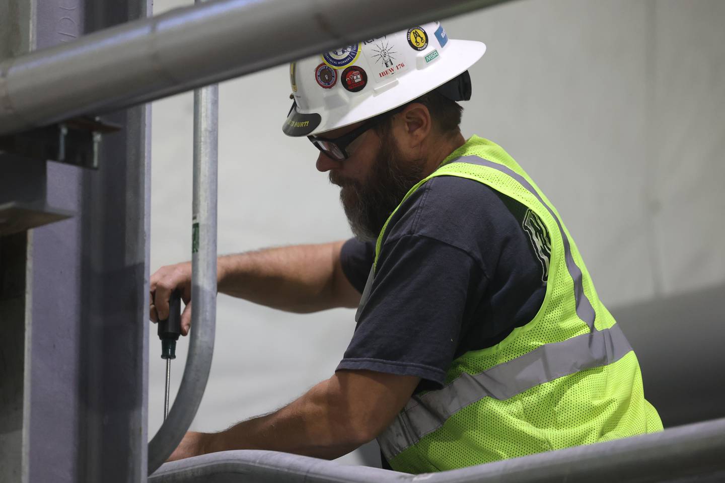 A worker tightens down pipes at the new Renewable Natural Gas Plant in Wilmington.