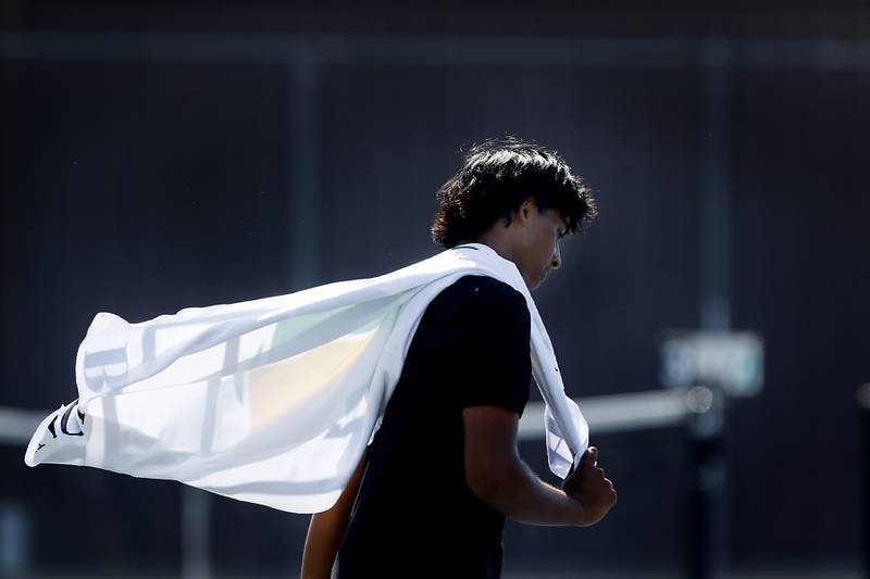Stevenson’s Nikhil Vijayakumar’s towel flies as he chases sides of the court as he competes in the Class 2A Boys State Tennis Tournament on Thursday, May 23, 2024, at Hersey High School in Arlington Heights.