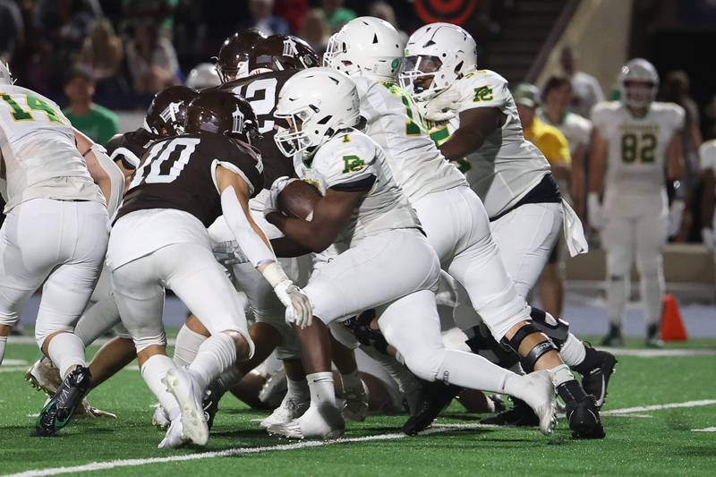 Providence’s Jamari Tribett rushes into the crowd of lineman against Joliet Catholic on Friday, Sept. 1, 2023 Joliet Memorial Stadium.