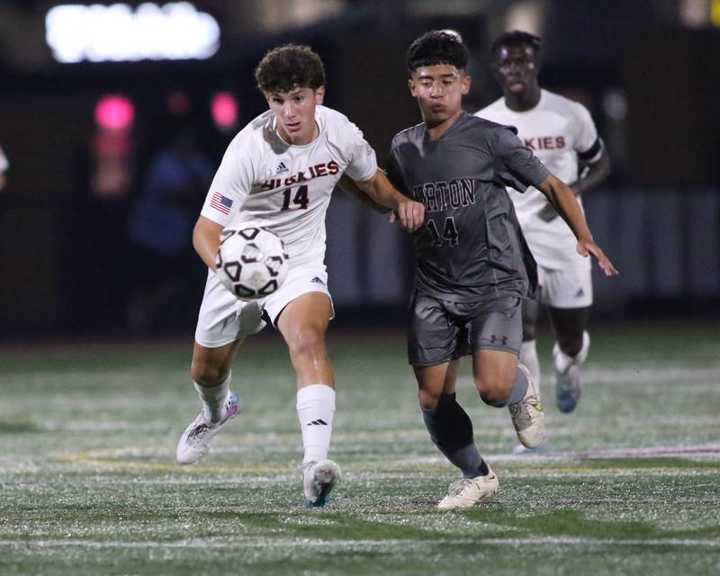 Naperville North's Niko Ladas (14) races down the pitch during soccer match between Naperville North at Morton.  Sept 21, 2023.