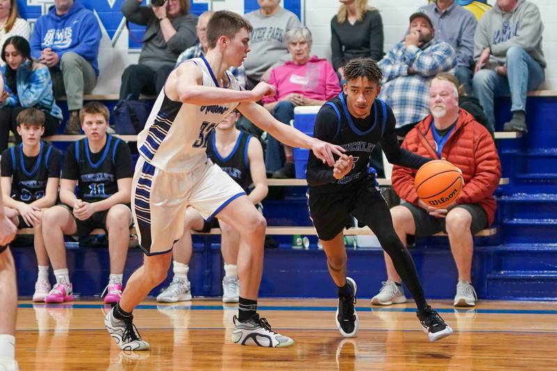 Hinckley-Big Rock's Alex Casanas (5) drives the baseline against Newark’s Cody Kulbartz (32) during a basketball game at Newark High School on Tuesday, January 28, 2025.