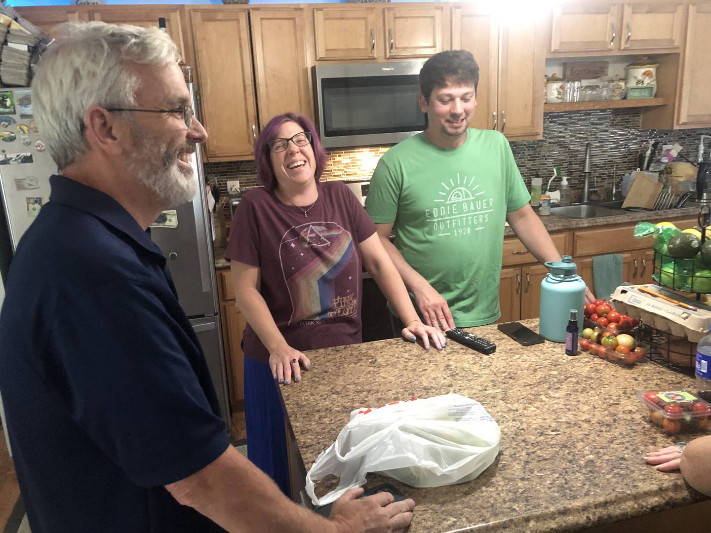 Mike Clark, left, joined neighbors Stephanie Tesmer and Chris Tesmer, in the Tesmer's Eastwood Manor kitchen on Friday, Aug. 15, 2025. For the first time in 70 years, water provided to the homes north of McHenry is filtered to remove high iron content.