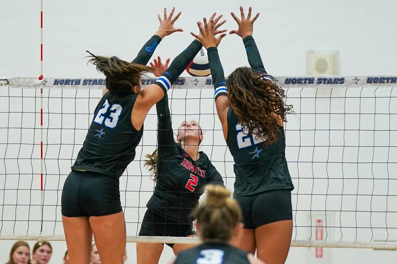 Huntley’s Rachael Hein (2) goes up for a kill attempt against St. Charles North's Haley Burgdorf (23) and Sidney Wright (22) during a non-conference match at St. Charles North High School on Wednesday, Sept. 3, 2025.