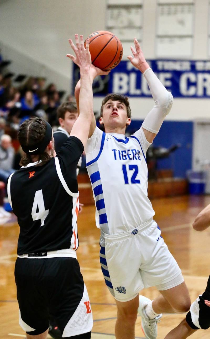 Princeton's Tyson Phillips shoots over Kewanee's Blaise Lewis Tuesday night at Prouty Gym. The Tigers won 61-55.