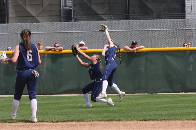 Marquette's Nora Rinearson makes a catch in right-center field as teammate Lindsey Kaufmann backs her up during the Class 1A Supersectional game on Monday, May 29, 2023 at Illinois Wesleyan University in Bloomington.