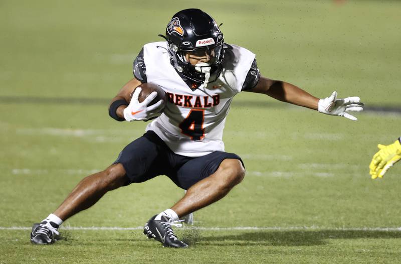 DeKalb's Xavier Dandridge carries the ball after a screen pass during their game Friday, Sept 15, 2023, at Metea Valley High School in Aurora.